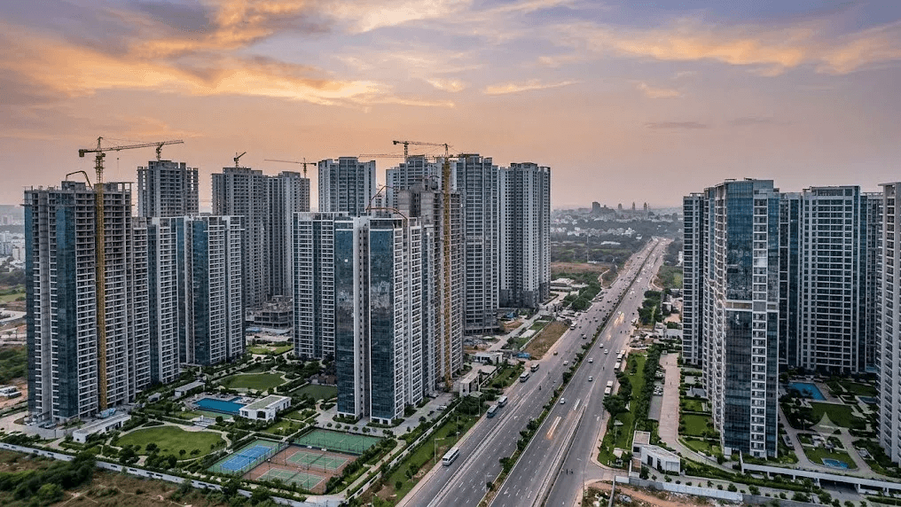 Residential towers and a tree-lined boulevard at sunset